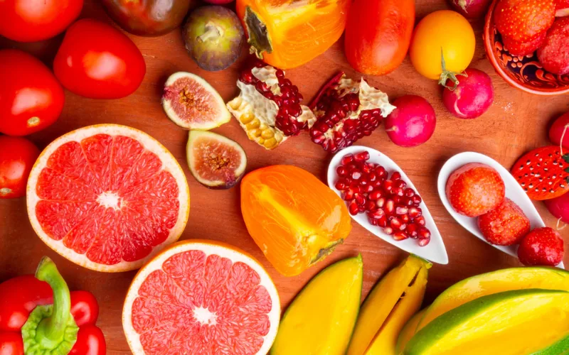 Frutas y verduras rojas y anaranjadas como tomate, pomelo, granada y pimiento